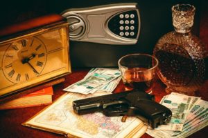 safety deposit box with gun and drink